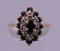 A 14 K gold diamond and sapphire ring. Ring size M/N. 2.8 grammes total weight.