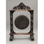 A Victorian carved oak gong. 104 cm high.