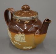 A Doulton Lambeth stoneware teapot with silver rim. 10 cm high.