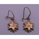 A pair of 9 ct gold diamond set star shaped earrings. 2.1 grammes total weight.