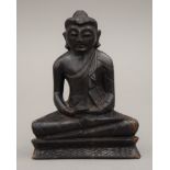 A carved wooden model of Buddha. 11.5 cm high.