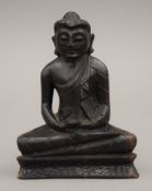 A carved wooden model of Buddha. 11.5 cm high.