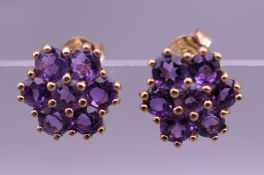 A pair of 9 ct gold amethyst daisy cluster earrings. 8 mm wide.