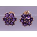 A pair of 9 ct gold amethyst daisy cluster earrings. 8 mm wide.