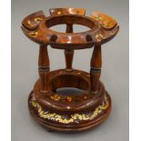 A Continental wooden bottle stand. 19 cm high.