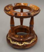 A Continental wooden bottle stand. 19 cm high.