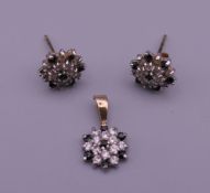 A pair of 9 ct gold and white gold sapphire earrings and matching pendant. 1.7 grammes total weight.
