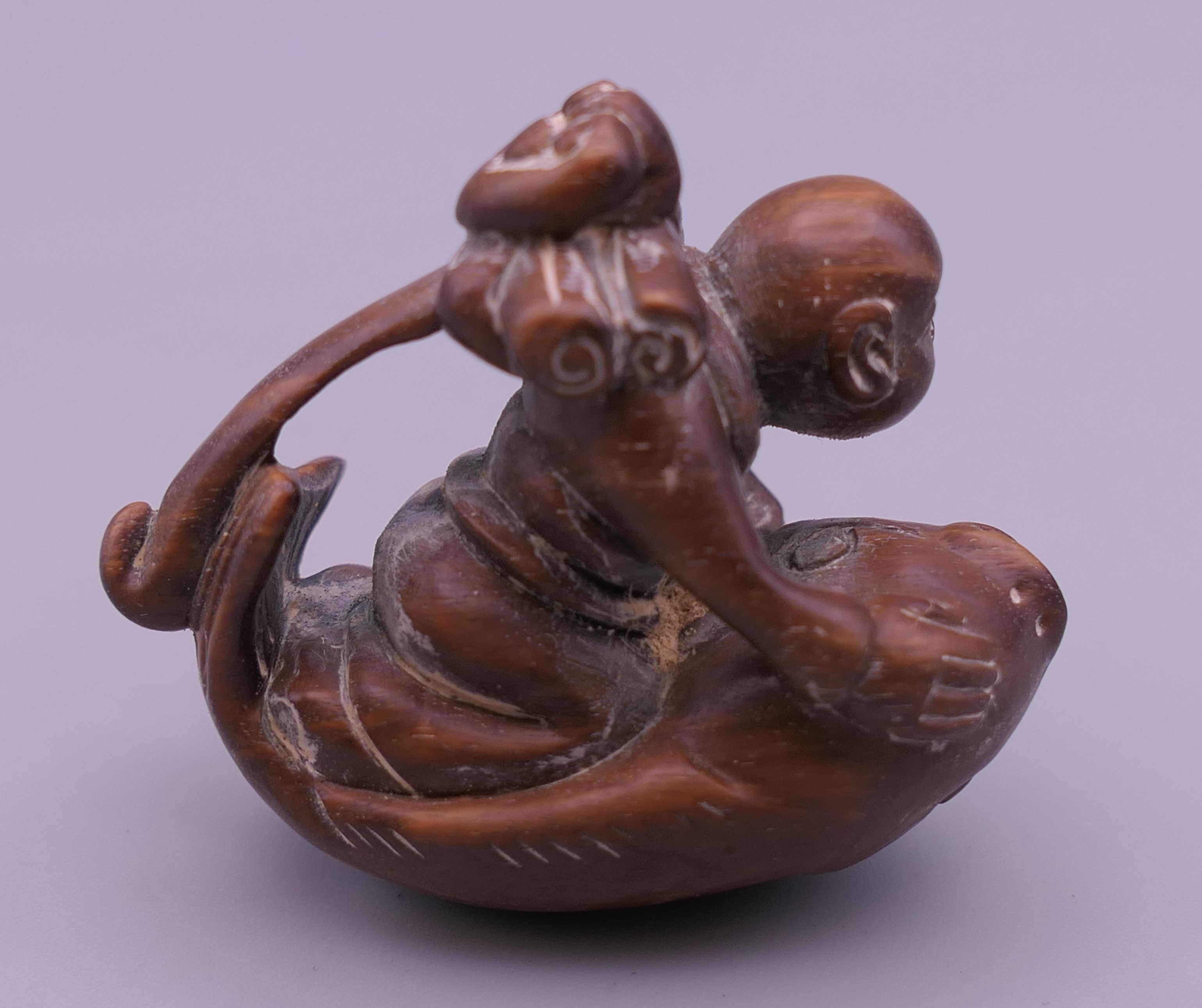 An Oriental carving formed as a man with a fish. 4.5 cm long. - Image 2 of 4