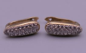 A pair of 9 ct gold earrings. 12 mm high.