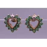 A pair of 9 ct gold emerald and diamond heart shaped earrings. 9 mm high.