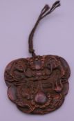 A Chinese carved dragon pendant. 8 cm wide.