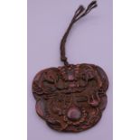 A Chinese carved dragon pendant. 8 cm wide.