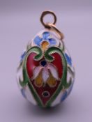 A Russian silver enamel egg pendant. 3 cm high.