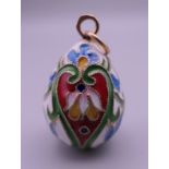 A Russian silver enamel egg pendant. 3 cm high.