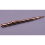 A 9 ct gold pencil. 12 cm long. 17.4 grammes total weight.