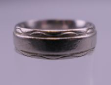 A platinum wedding ring. Ring size J. 10 grammes.