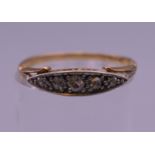 An 18 ct gold and diamond navette ring. Ring size N. 1.8 grammes total weight.