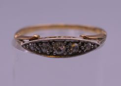 An 18 ct gold and diamond navette ring. Ring size N. 1.8 grammes total weight.