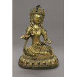 A gilt bronze model of Buddha. 20 cm high.