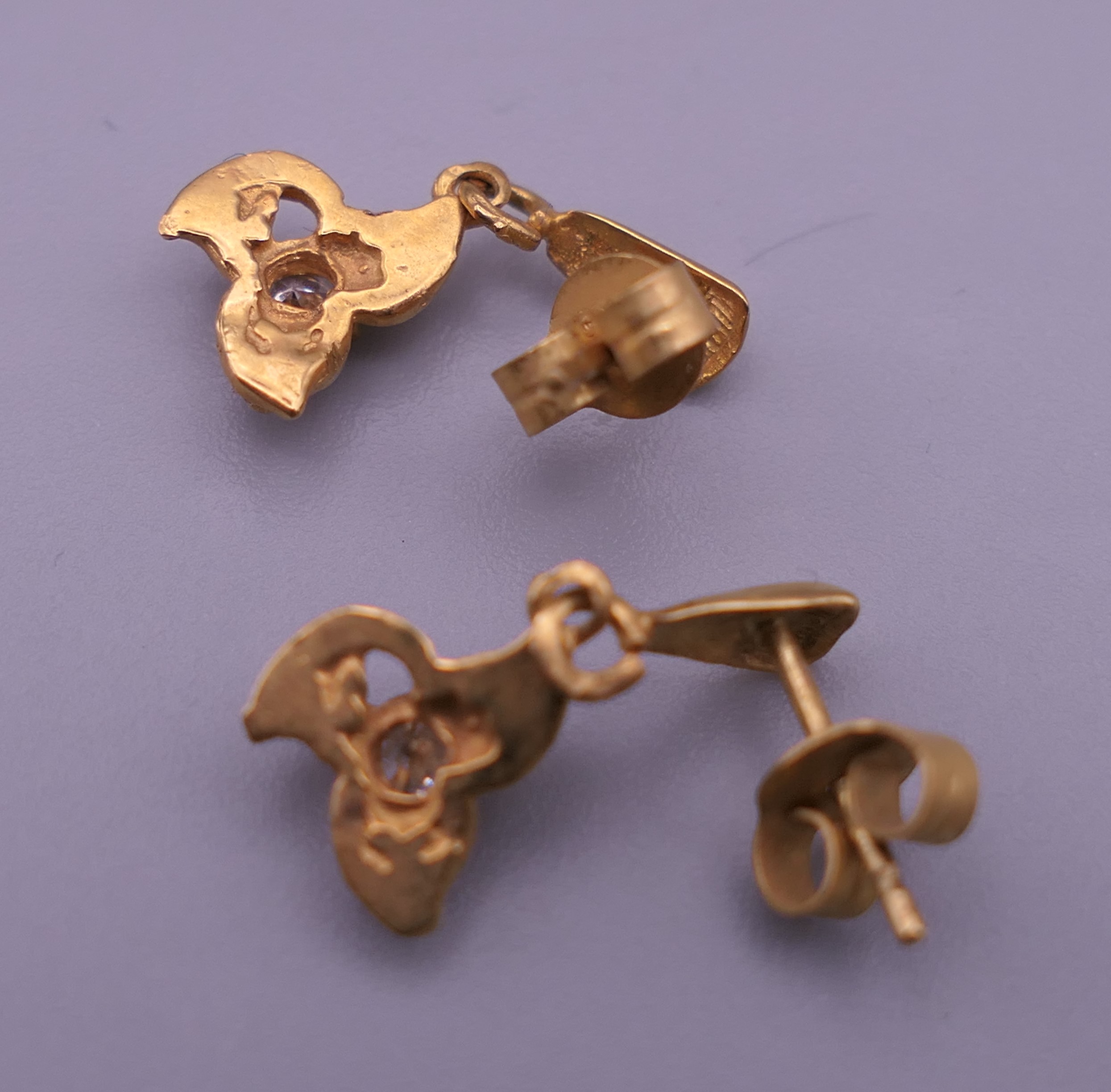 A pair of gold diamond set earrings. 1 cm high. 1.4 grammes total weight. - Image 2 of 5