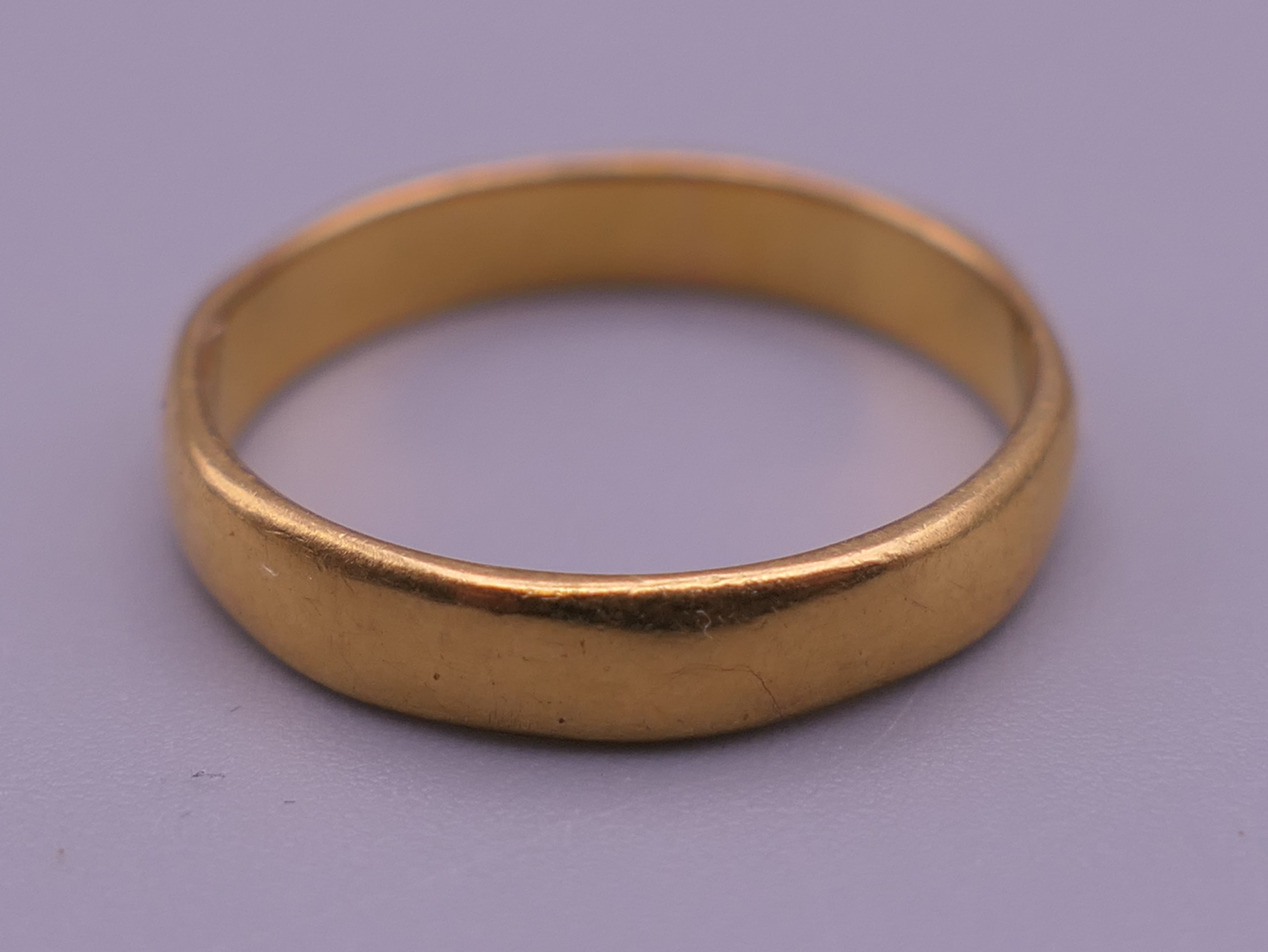 A 22 ct gold wedding band. Ring size N/O. 3.6 grammes.