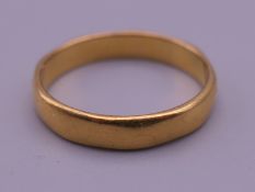 A 22 ct gold wedding band. Ring size N/O. 3.6 grammes.