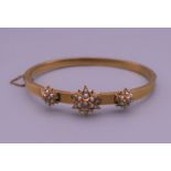 A Victorian 15 ct gold seed pearl and diamond bangle form bracelet. 6 cm wide. 8.
