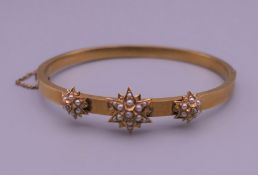 A Victorian 15 ct gold seed pearl and diamond bangle form bracelet. 6 cm wide. 8.