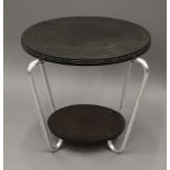 An Art Deco bakelite topped tubular table. 50.5 cm diameter.