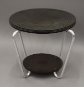 An Art Deco bakelite topped tubular table. 50.5 cm diameter.