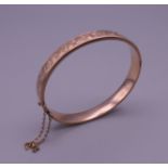 A 9 ct gold bangle bracelet. 6 cm wide. 10.8 grammes.
