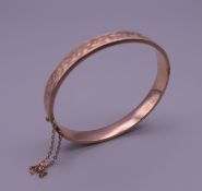 A 9 ct gold bangle bracelet. 6 cm wide. 10.8 grammes.