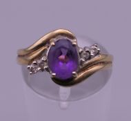 A 9 ct gold diamond and amethyst ring. Ring size N. 2.7 grammes total weight.