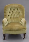 A Victorian upholstered button back arm chair. 65 cm wide.