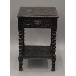 A Victorian carved oak single drawer side table. 45 cm wide.