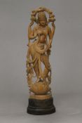 An Indian carved wooden model of a deity. 43 cm high.