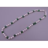 A jade and pearl necklace with a 14 ct gold clasp. 44 cm long.