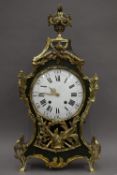 A 19th century French brass mounted green painted wooden mantle clock. 79 cm high.