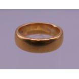A 22 ct gold wedding band. Ring size K/L. 8.8 grammes.
