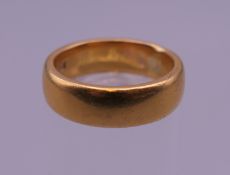 A 22 ct gold wedding band. Ring size K/L. 8.8 grammes.