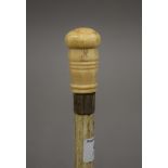 A 19th century whale bone and marine ivory walking stick. 84.5 cm long.