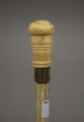 A 19th century whale bone and marine ivory walking stick. 84.5 cm long.