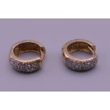 A pair of 9 ct gold diamond set earrings. 2.2 grammes total weight.
