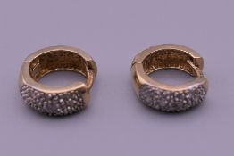 A pair of 9 ct gold diamond set earrings. 2.2 grammes total weight.