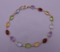 An 18 ct gold mutli-gem set bracelet. 16 cm long. 3.9 grammes total weight.