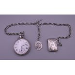A silver pocket watch, a silver chain and a silver vesta.