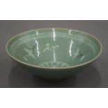 A celadon glaze bowl, the interior decorated with cranes, character marks to base. 15 cm diameter.