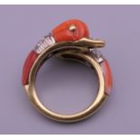 An 18 ct gold diamond and coral ring in the form of two dolphins.