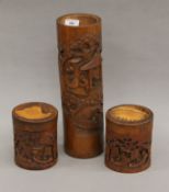 Two Chinese carved bamboo boxes and a Chinese carved bamboo brush pot. The latter 35 cm high.