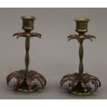 A pair of Arts and Crafts copper and brass candlesticks in the manner of W A S Benson. 15 cm high.